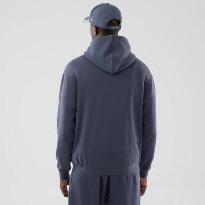The model is wearing this New Era Tech Oversized Pullover Hoodie in grey. 2