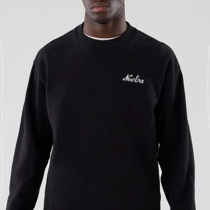 The model is wearing this New Era Oversized Crew Neck Sweater in black. 3