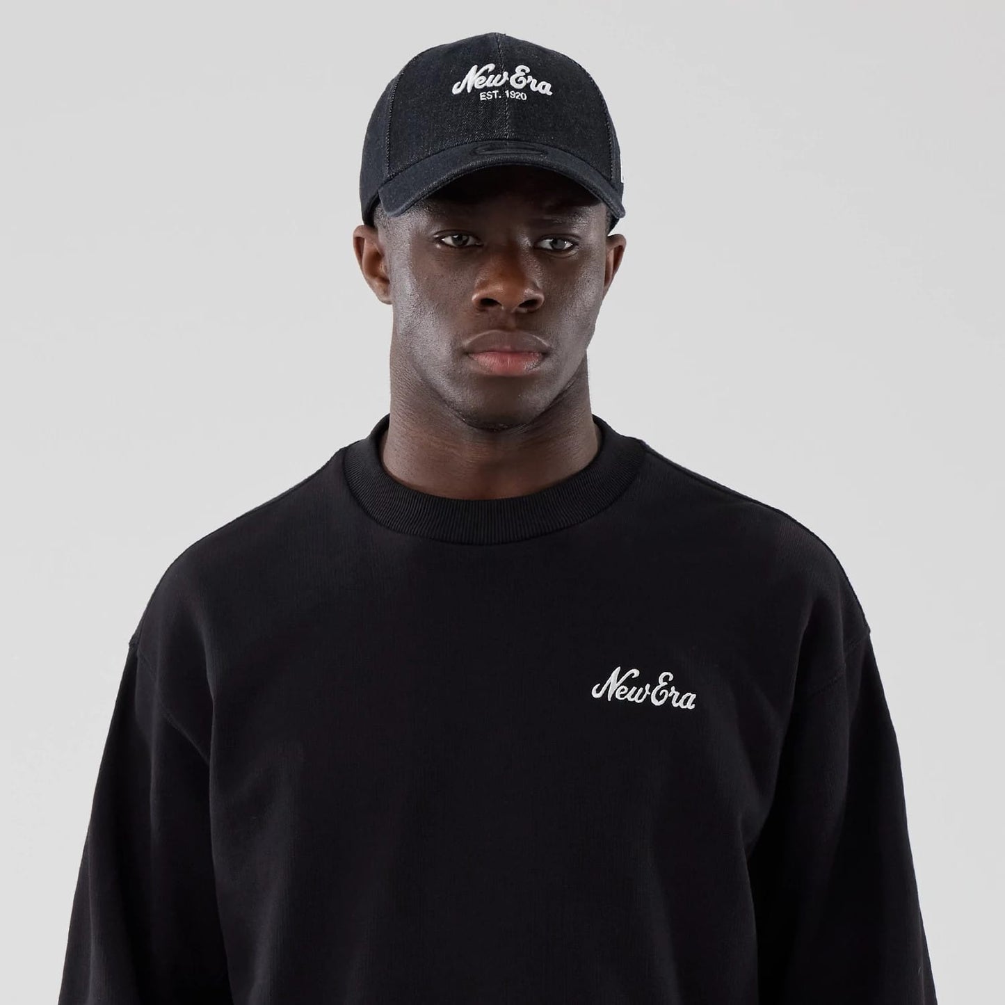 The model is wearing this New Era Oversized Crew Neck Sweater in black. 6