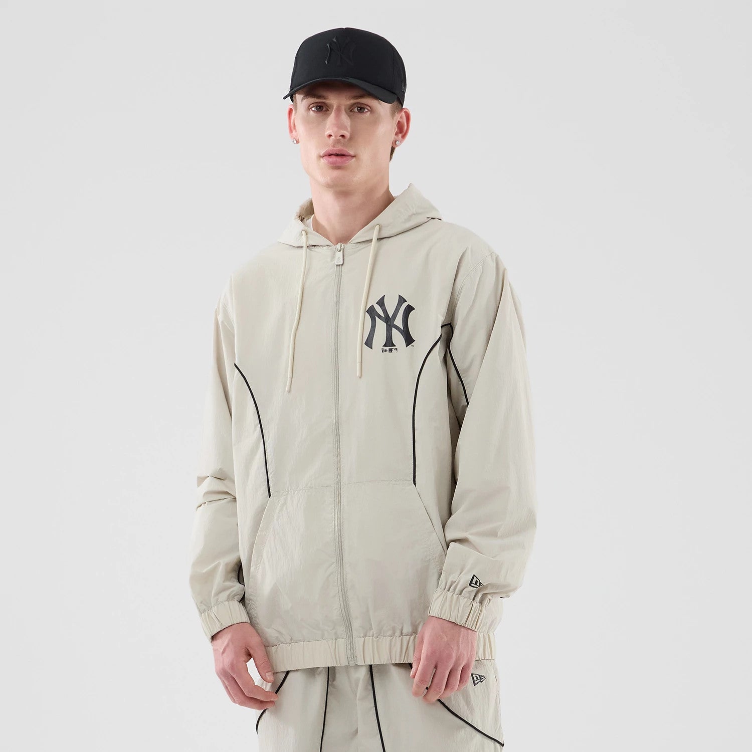 The model is wearing this MLB Piping New York Yankees Jacket in cream. 1