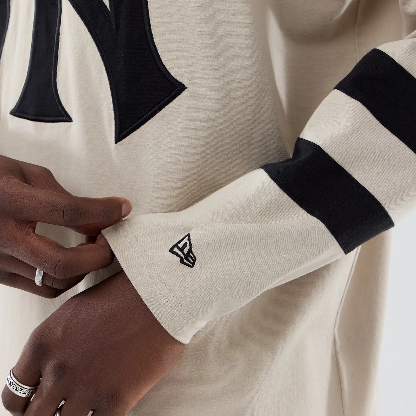 The model is wearing this MLB New York Yankees Oversized Long Sleeve T-Shirt in light beige. 5