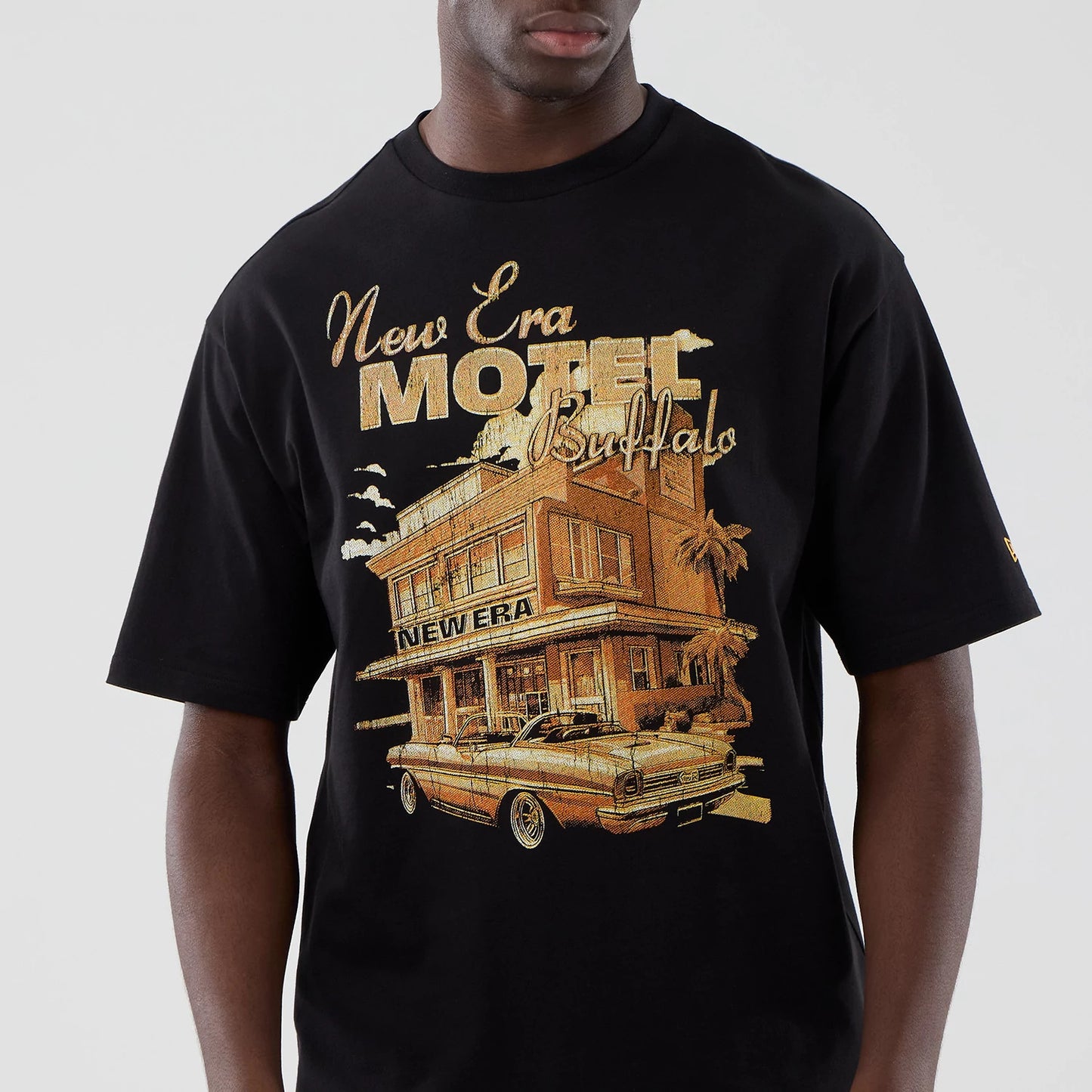 The model is wearing this New Era Motor Graphic Oversized T-Shirt in black. 3