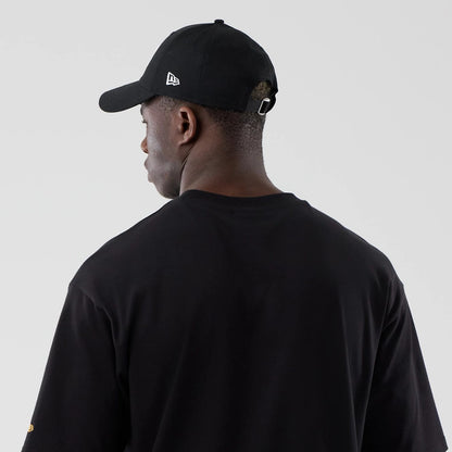 The model is wearing this New Era Motor Graphic Oversized T-Shirt in black. 7