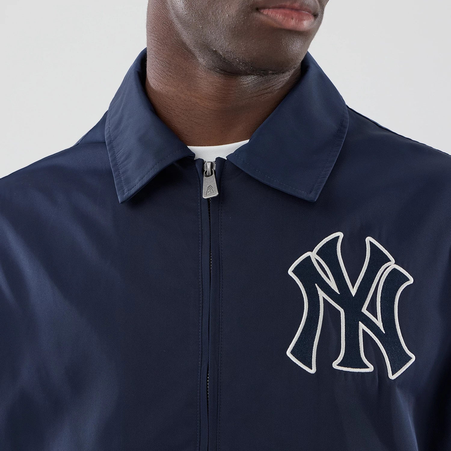 The model is wearing this MLB Collared New York Yankees Jacket in navy. 4