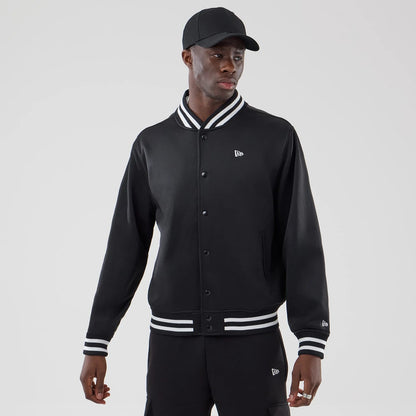 The model is wearing this New Era Jersey Bomber Jacket in black. 1