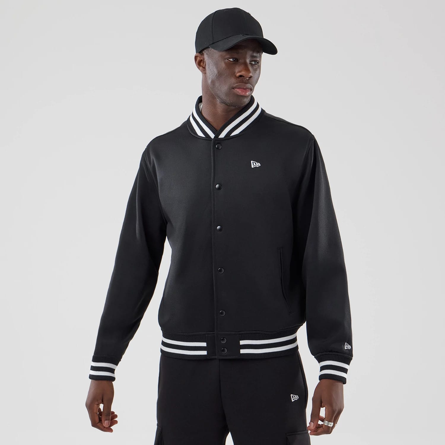 The model is wearing this New Era Jersey Bomber Jacket in black. 1