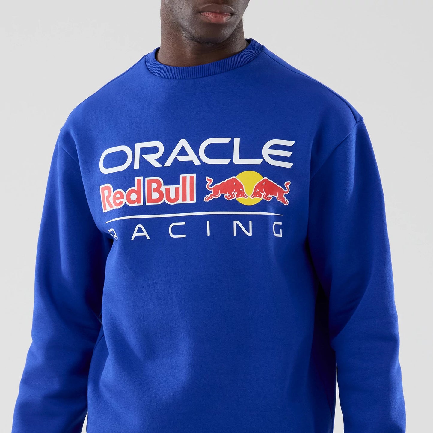 The model is wearing this Red Bull Racing Oversized Crew Neck Sweater in blue. 3