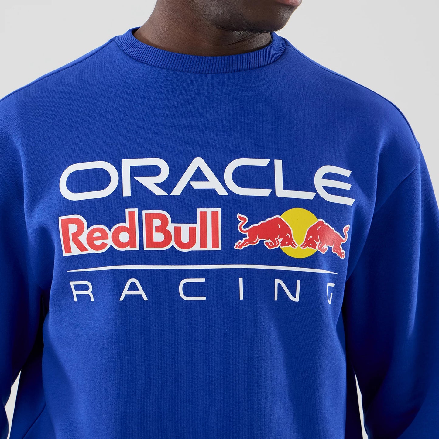 The model is wearing this Red Bull Racing Oversized Crew Neck Sweater in blue. 4