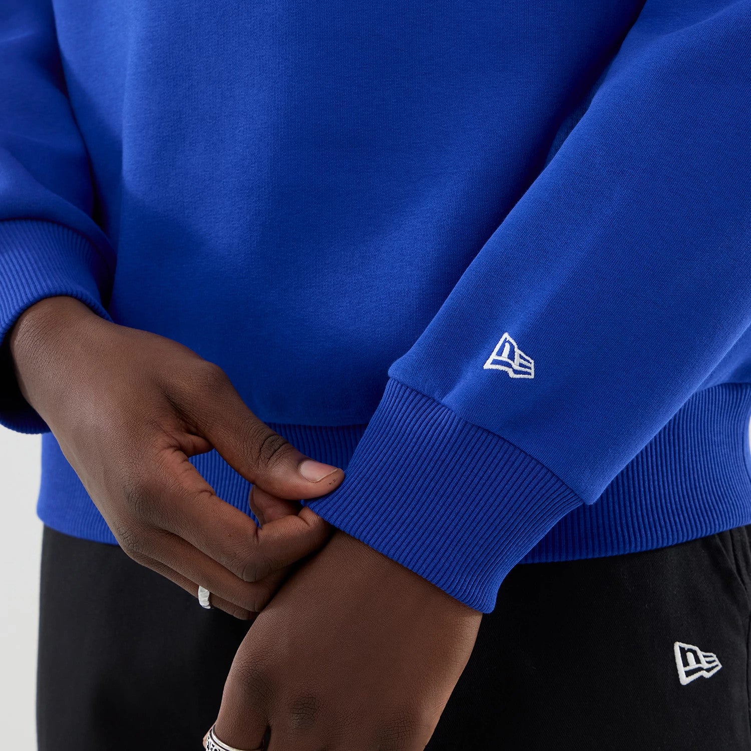 The model is wearing this Red Bull Racing Oversized Crew Neck Sweater in blue. 5
