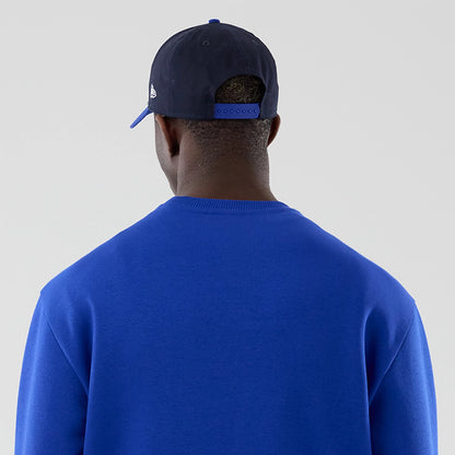 The model is wearing this Red Bull Racing Oversized Crew Neck Sweater in blue. 7