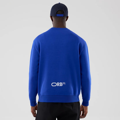 The model is wearing this Red Bull Racing Oversized Crew Neck Sweater in blue. 2