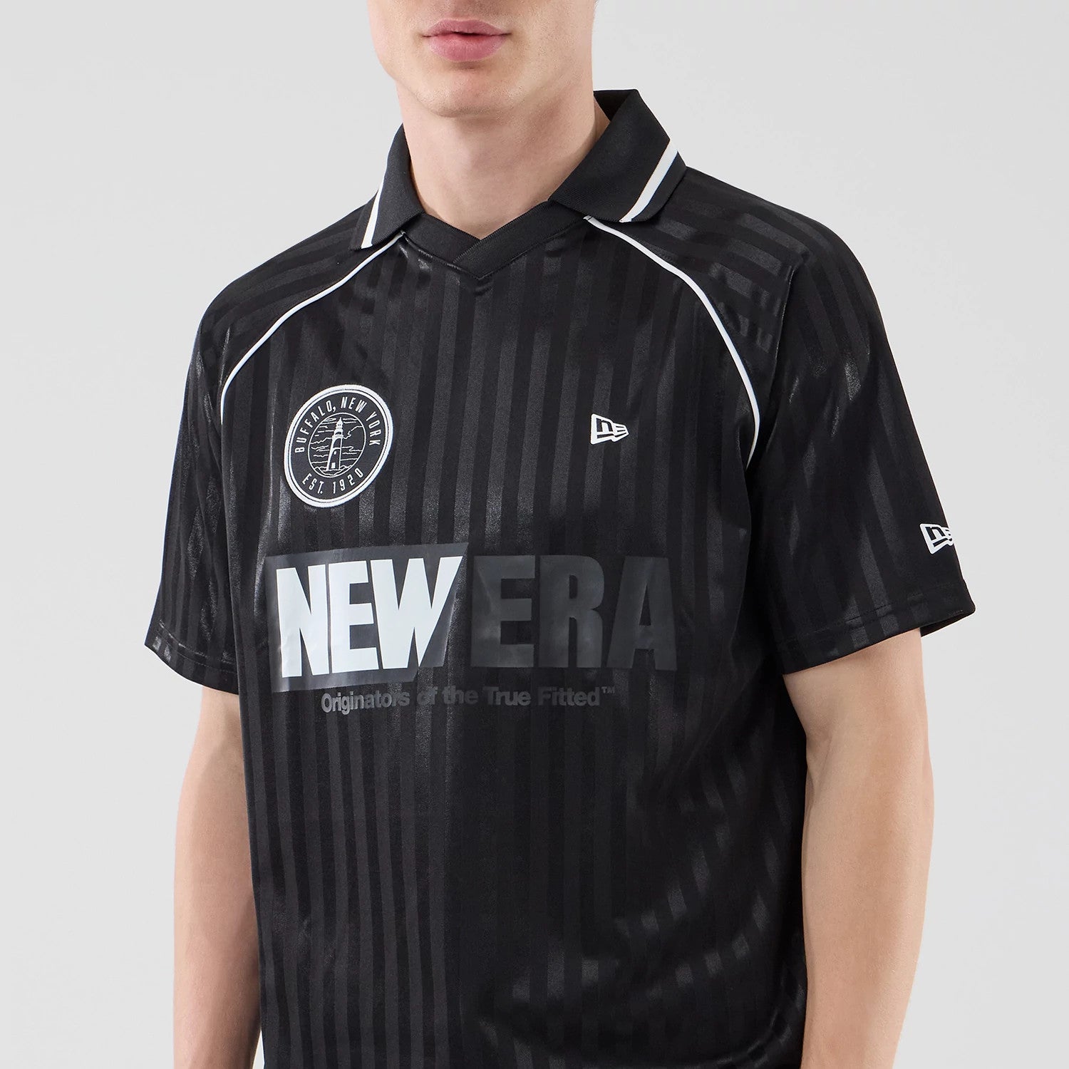 The model is wearing this New Era Football Jersey T-Shirt in black. 3