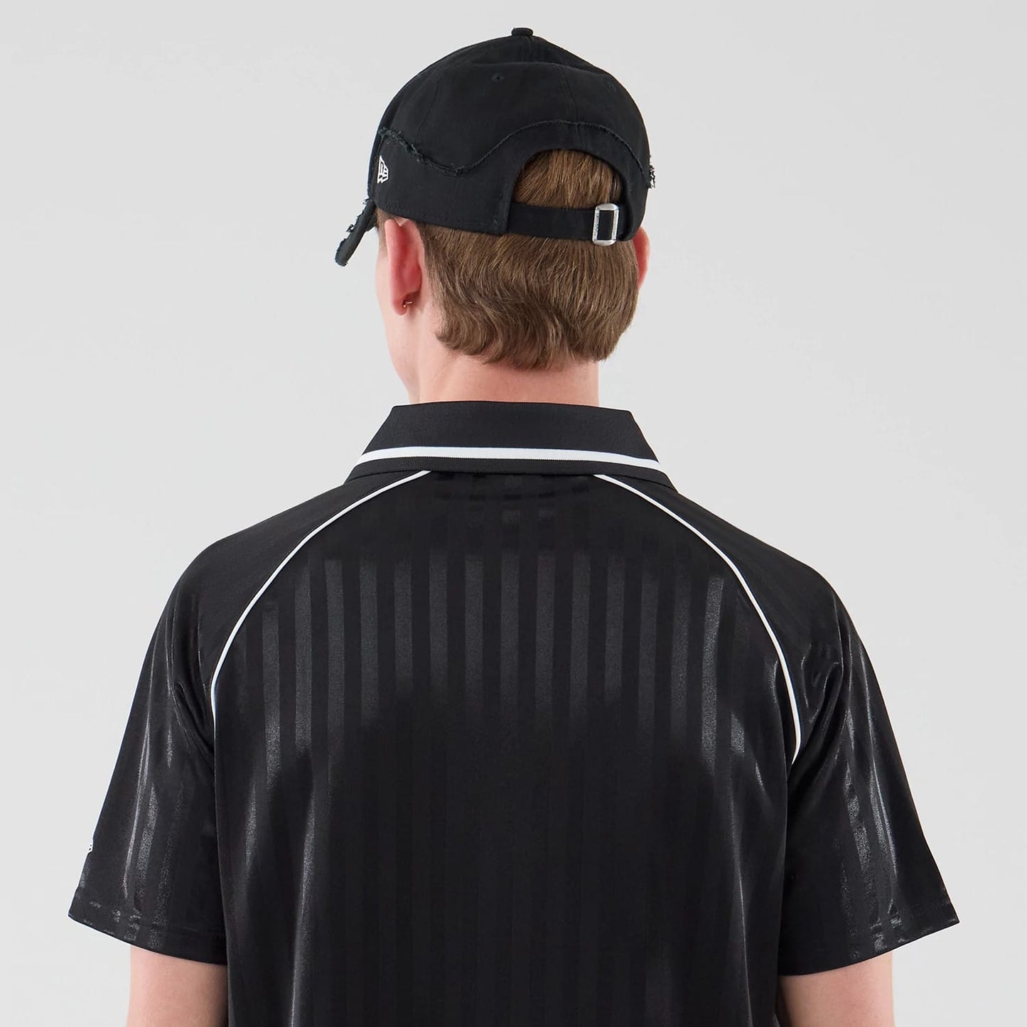 The model is wearing this New Era Football Jersey T-Shirt in black. 7