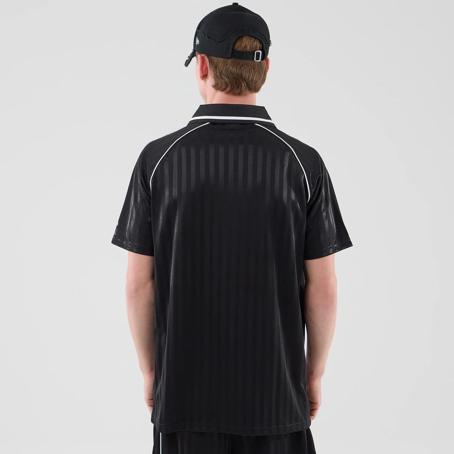 The model is wearing this New Era Football Jersey T-Shirt in black. 2