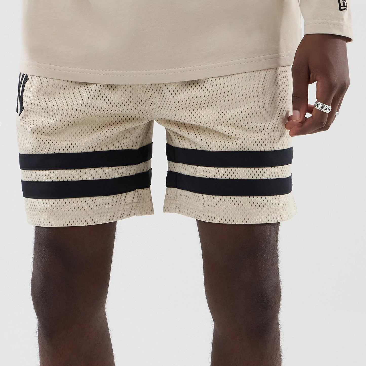 The model is wearing these MLB New York Yankees Oversized Mesh Shorts in light beige. 5