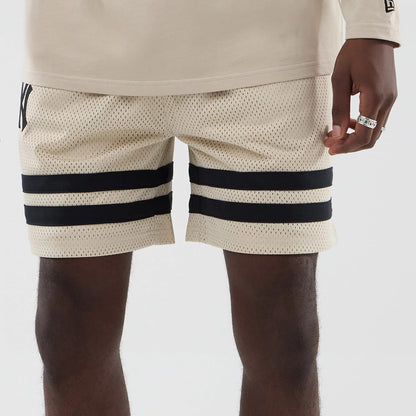 The model is wearing these MLB New York Yankees Oversized Mesh Shorts in light beige. 5