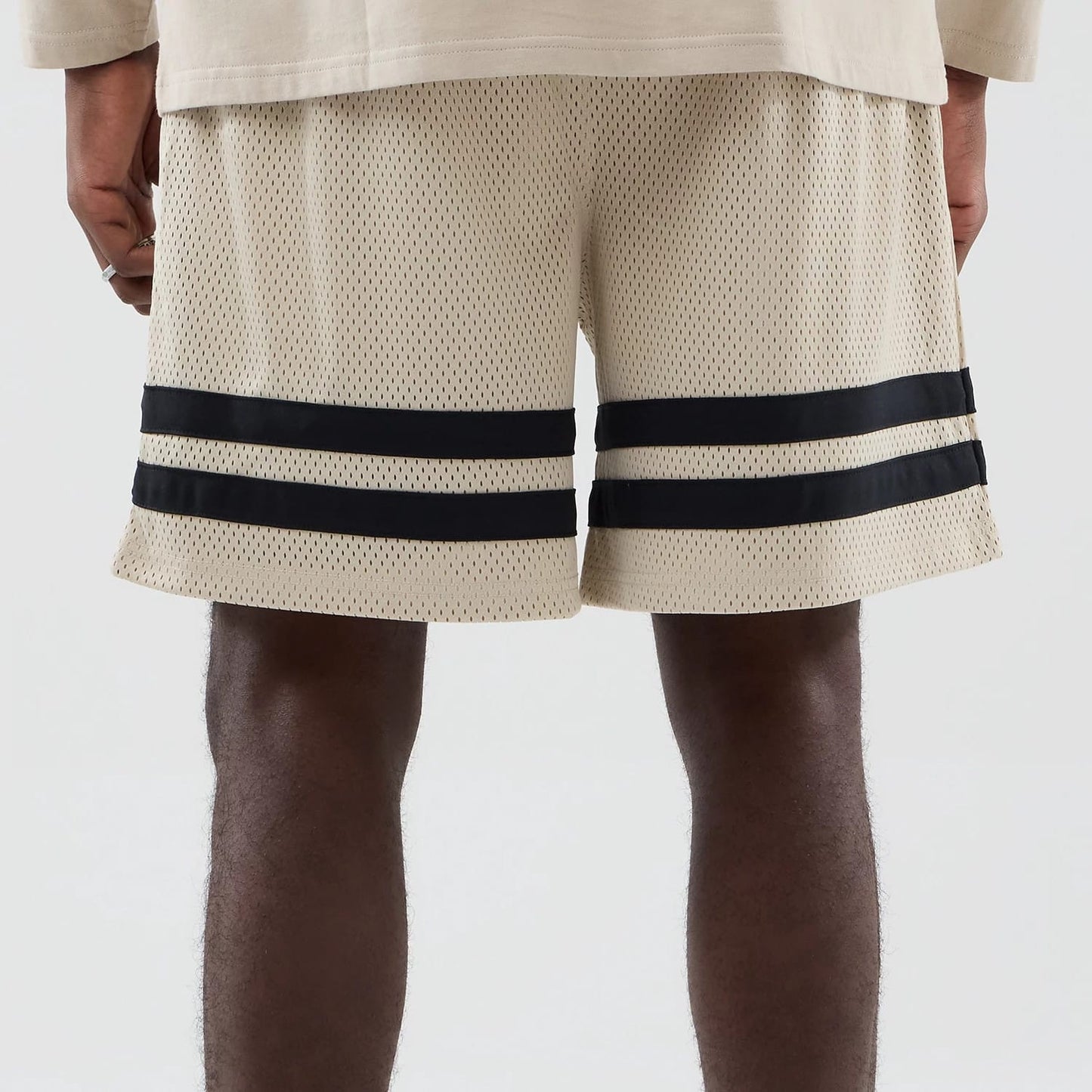 The model is wearing these MLB New York Yankees Oversized Mesh Shorts in light beige. 6
