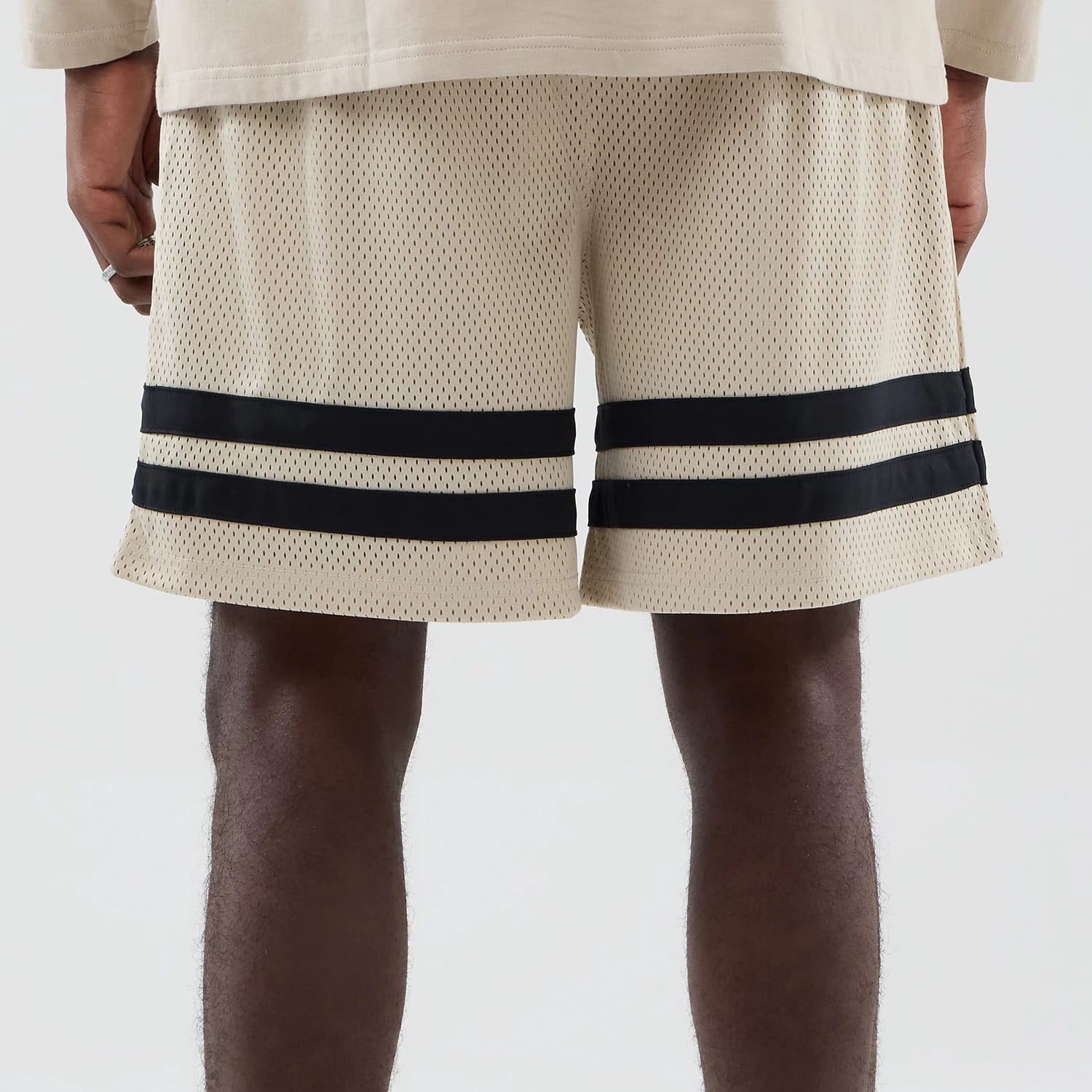 The model is wearing these MLB New York Yankees Oversized Mesh Shorts in light beige. 6