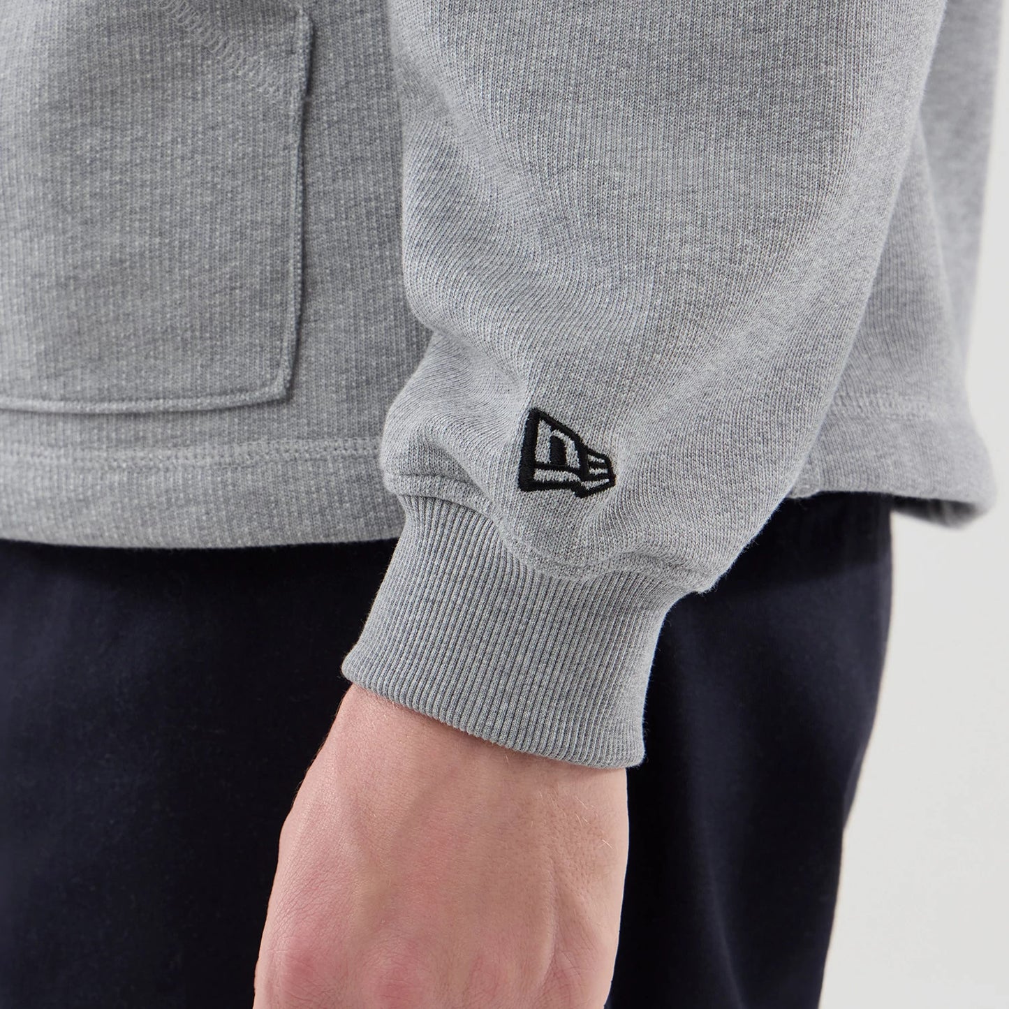 The model is wearing this New Era Open Hem Pullover Hoodie in grey. 5