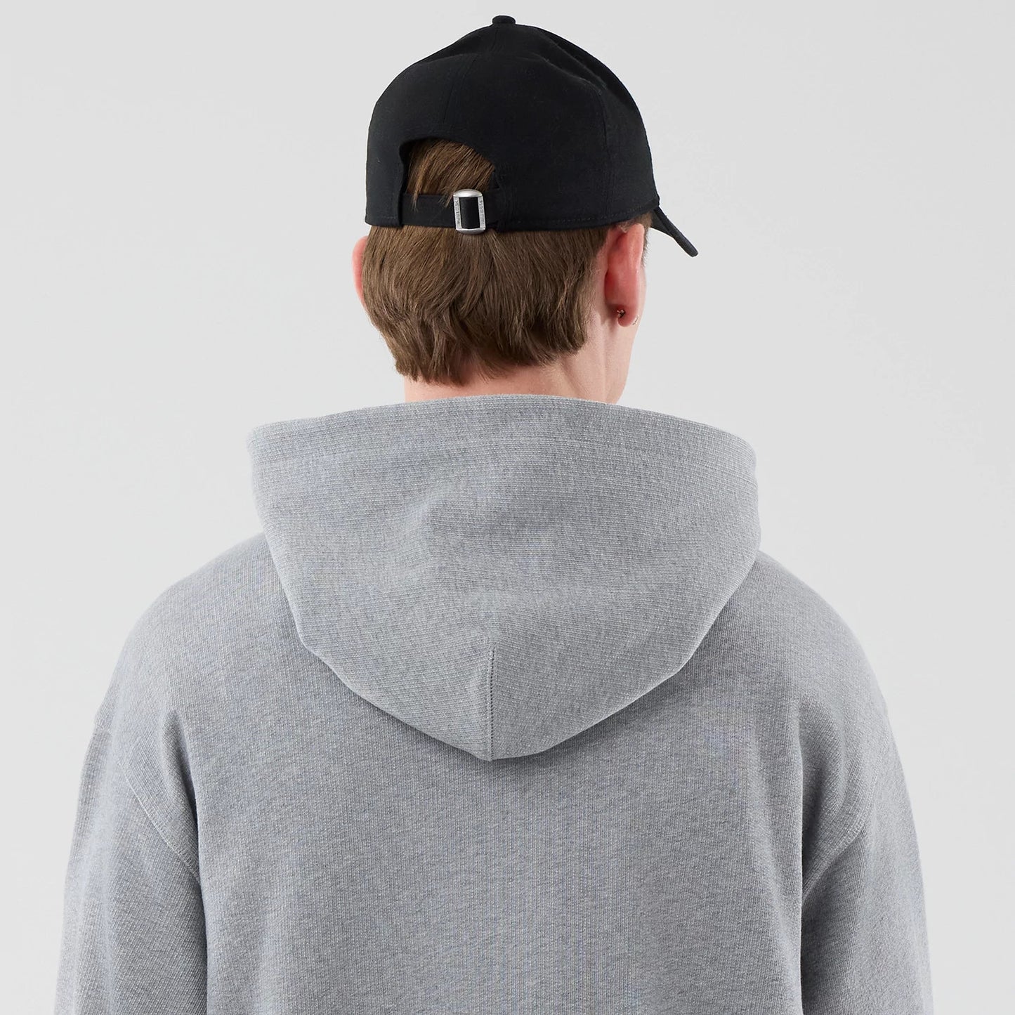 The model is wearing this New Era Open Hem Pullover Hoodie in grey. 7