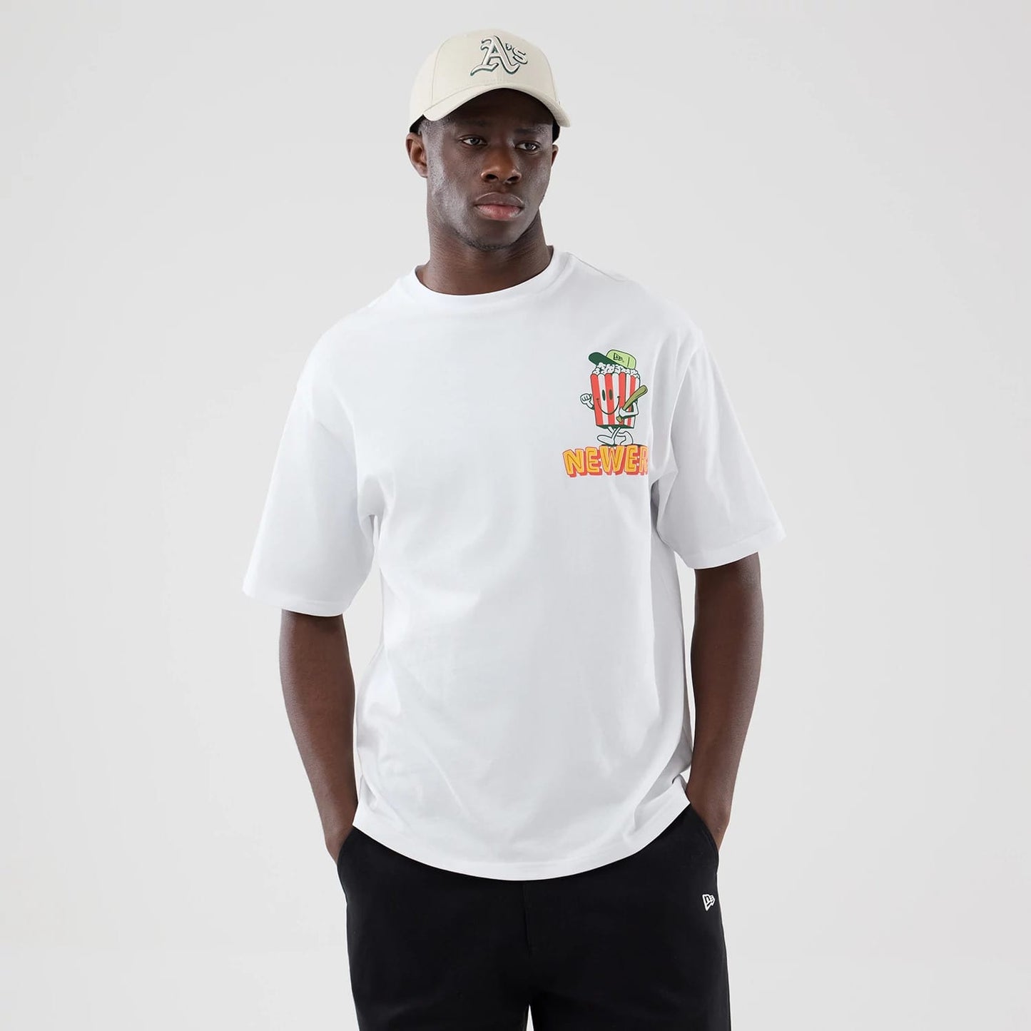 The model is wearing this New Era Food Graphic Oversized T-Shirt in white. 3