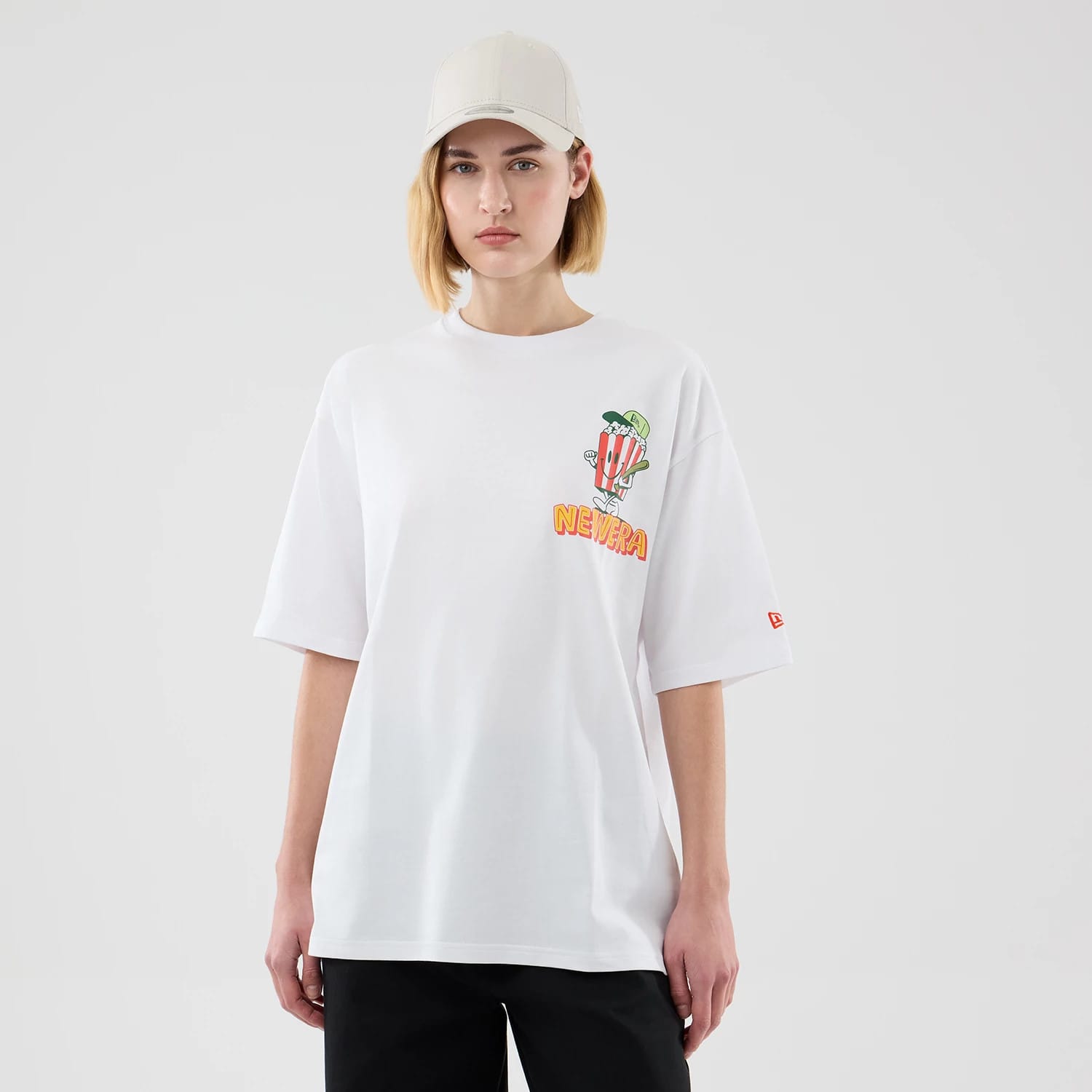 The model is wearing this New Era Food Graphic Oversized T-Shirt in white. 4