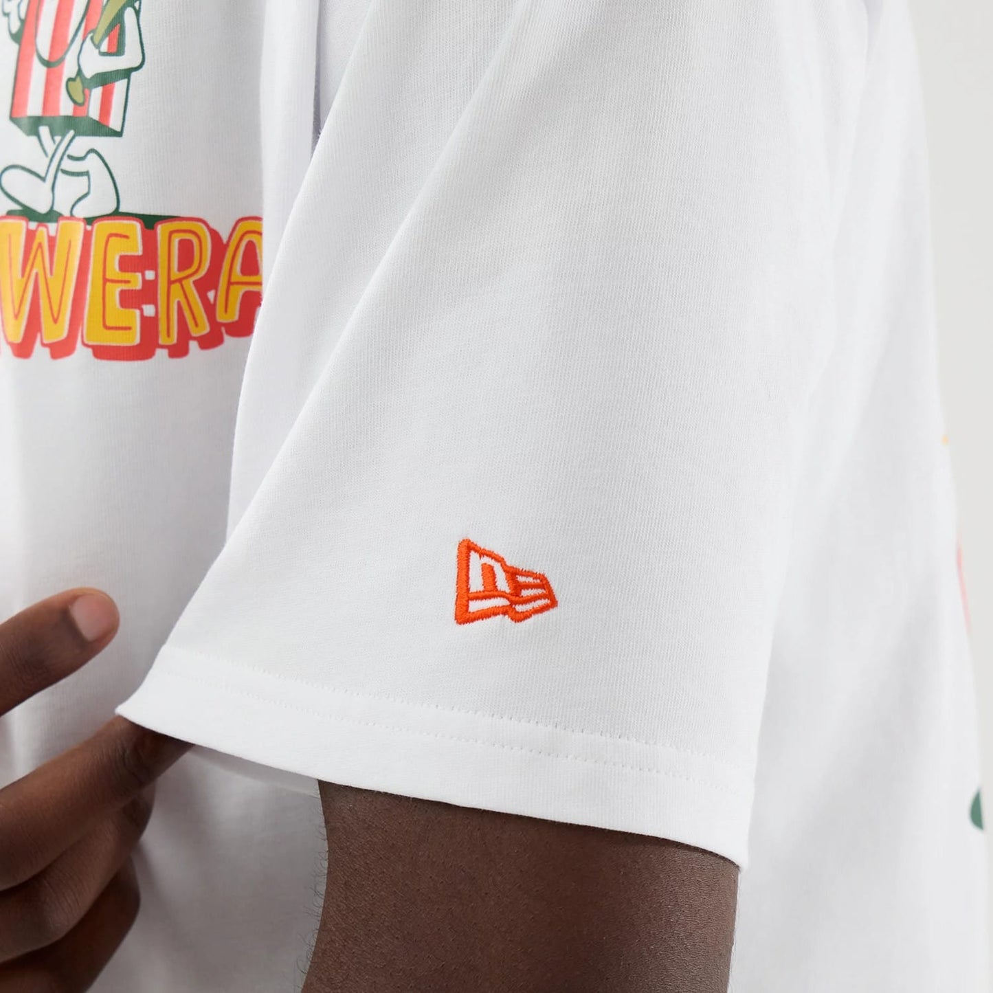 The model is wearing this New Era Food Graphic Oversized T-Shirt in white. 7