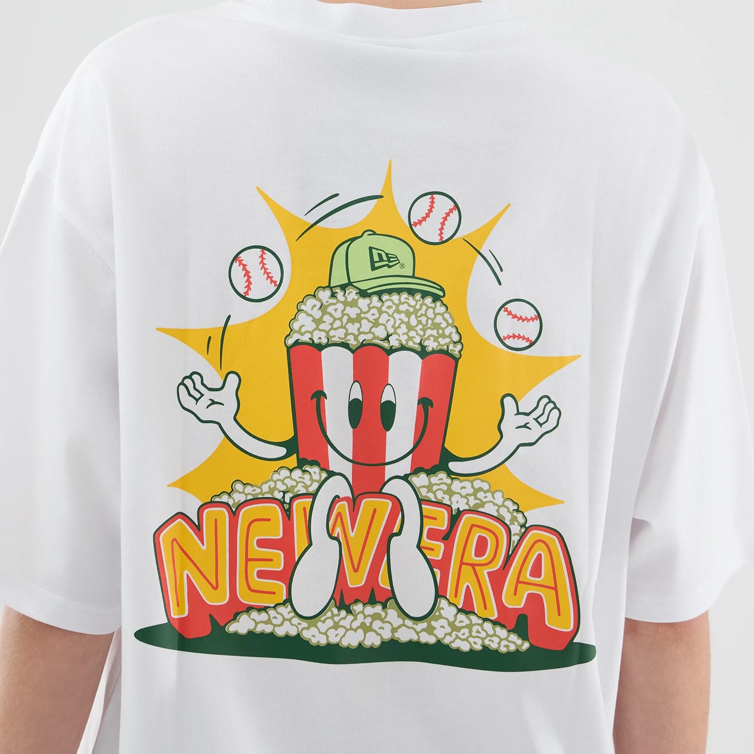 The model is wearing this New Era Food Graphic Oversized T-Shirt in white. 8