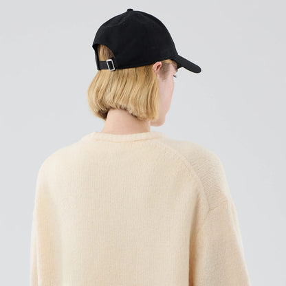 The model is wearing this New Era Knit Knitted Sweater in cream. 8