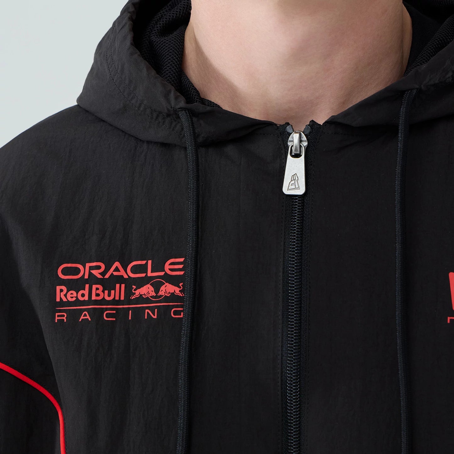 The model is wearing this Red Bull Racing Piping Track Jacket in black. 4