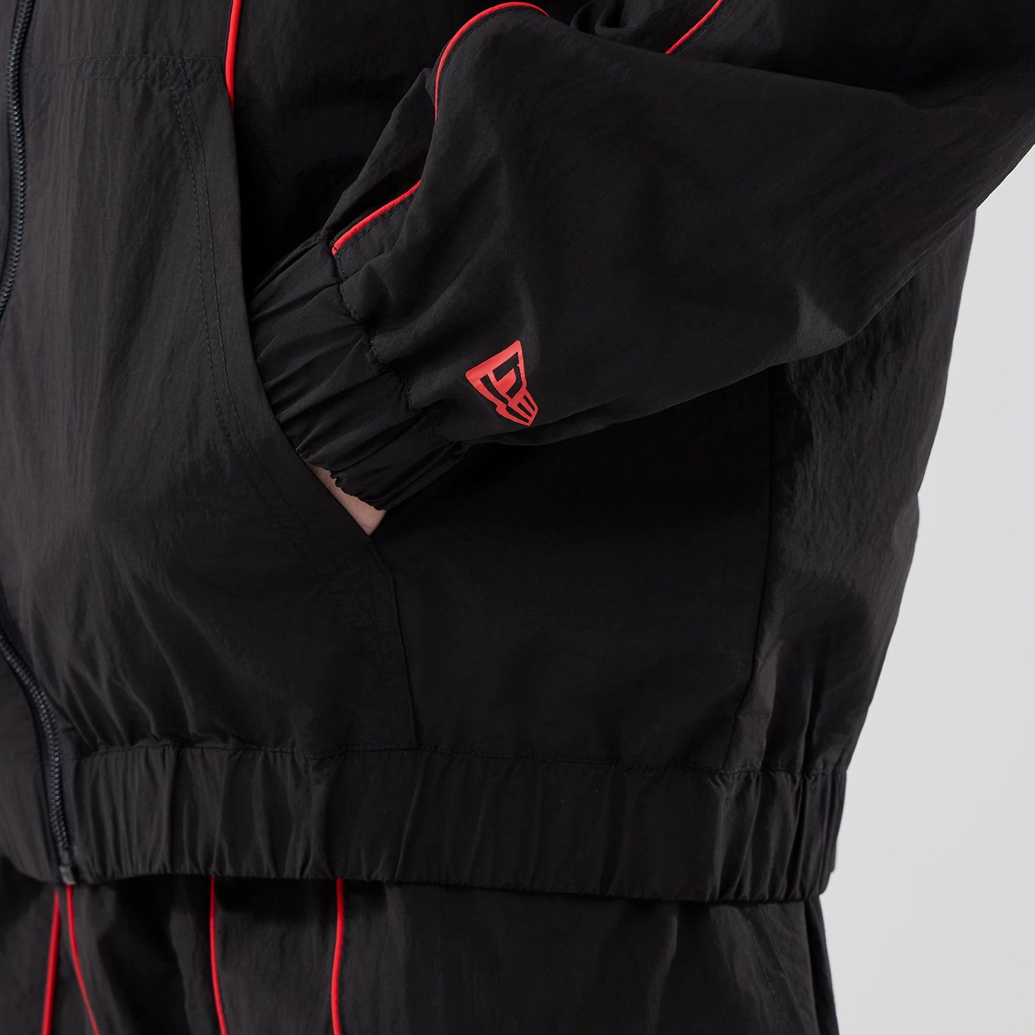 The model is wearing this Red Bull Racing Piping Track Jacket in black. 5