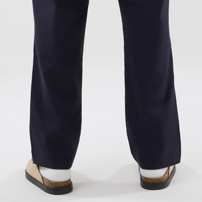 The model is wearing these New Era Chino Trousers in navy. 7