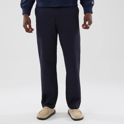 The model is wearing these New Era Chino Trousers in navy. 1