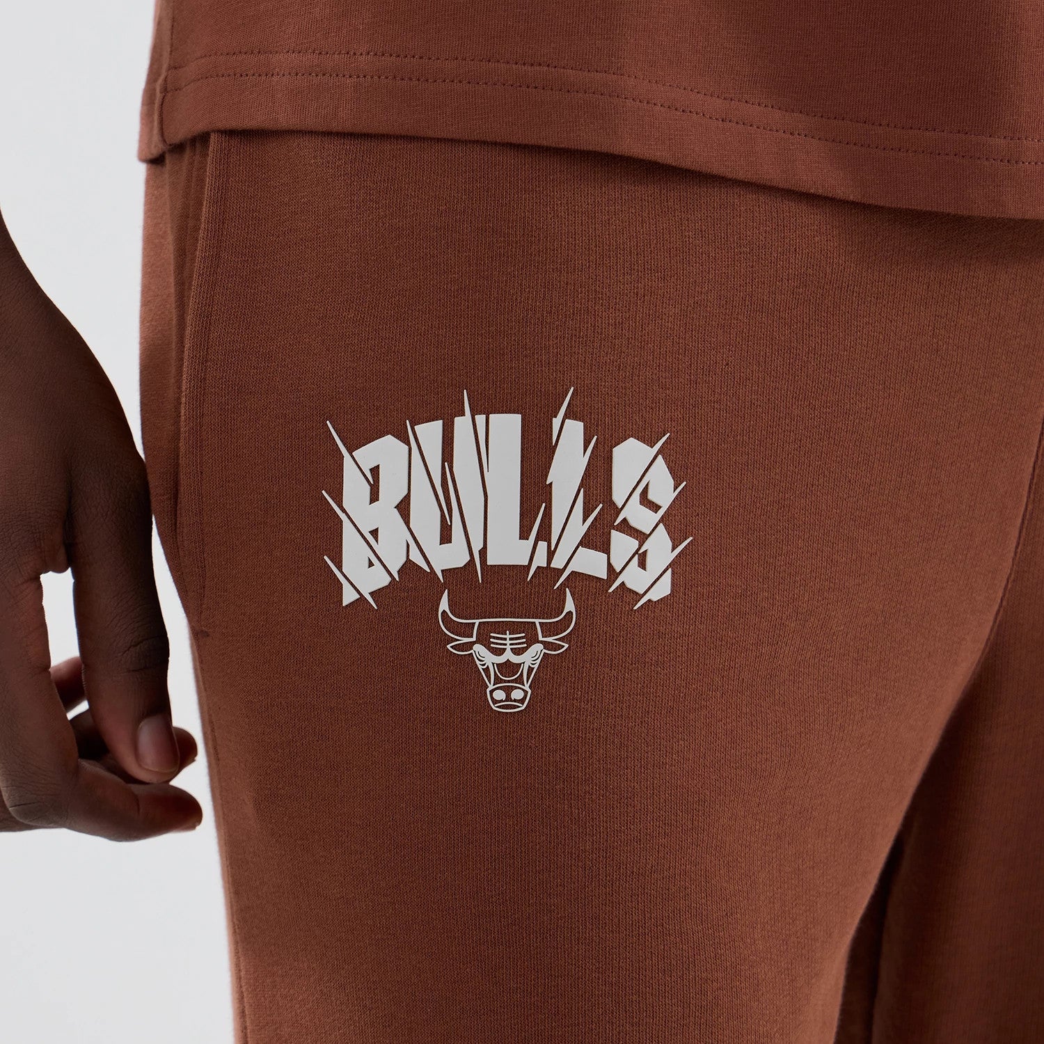 The model is wearing these NBA Core Plus Chicago Bulls Straight Leg Joggers in brown. 4