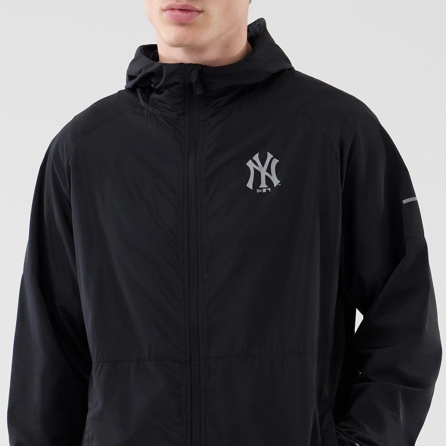 The model is wearing this MLB Core Plus Windbreaker New York Yankees Jacket in black. 3
