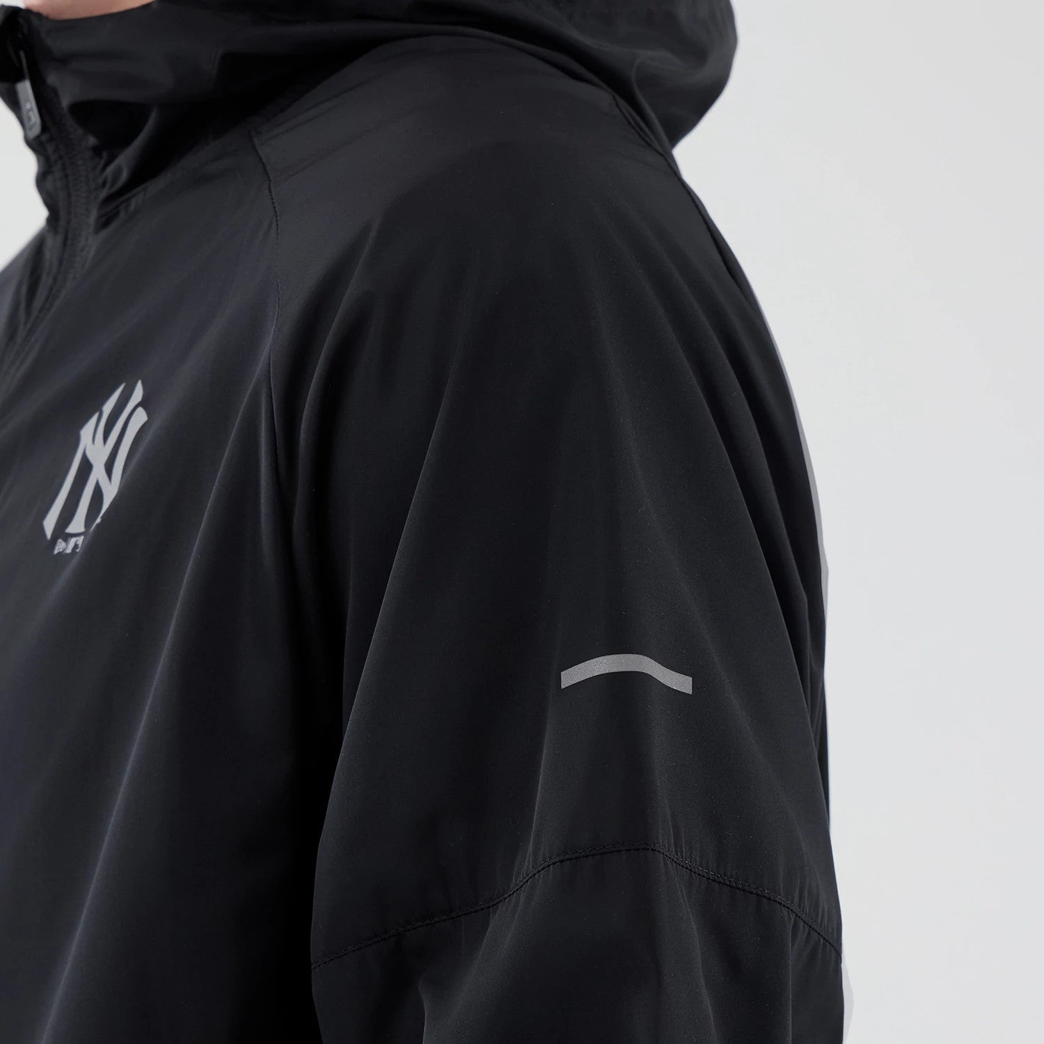 The model is wearing this MLB Core Plus Windbreaker New York Yankees Jacket in black. 6