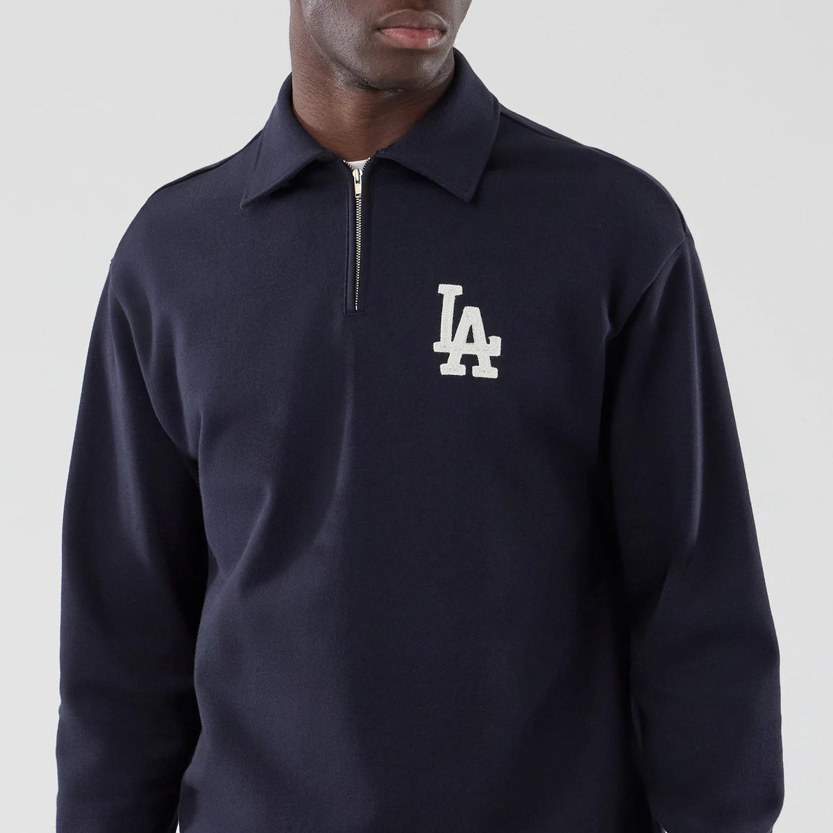 The model is wearing this MLB LA Dodgers Oversized 1/4 Zip Sweater in navy. 3