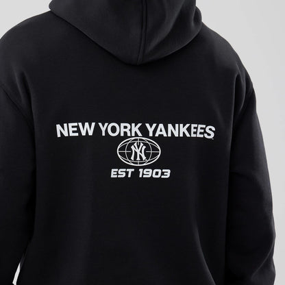 The model is wearing this MLB Logo Graphic New York Yankees Oversized Pullover Hoodie in black. 5