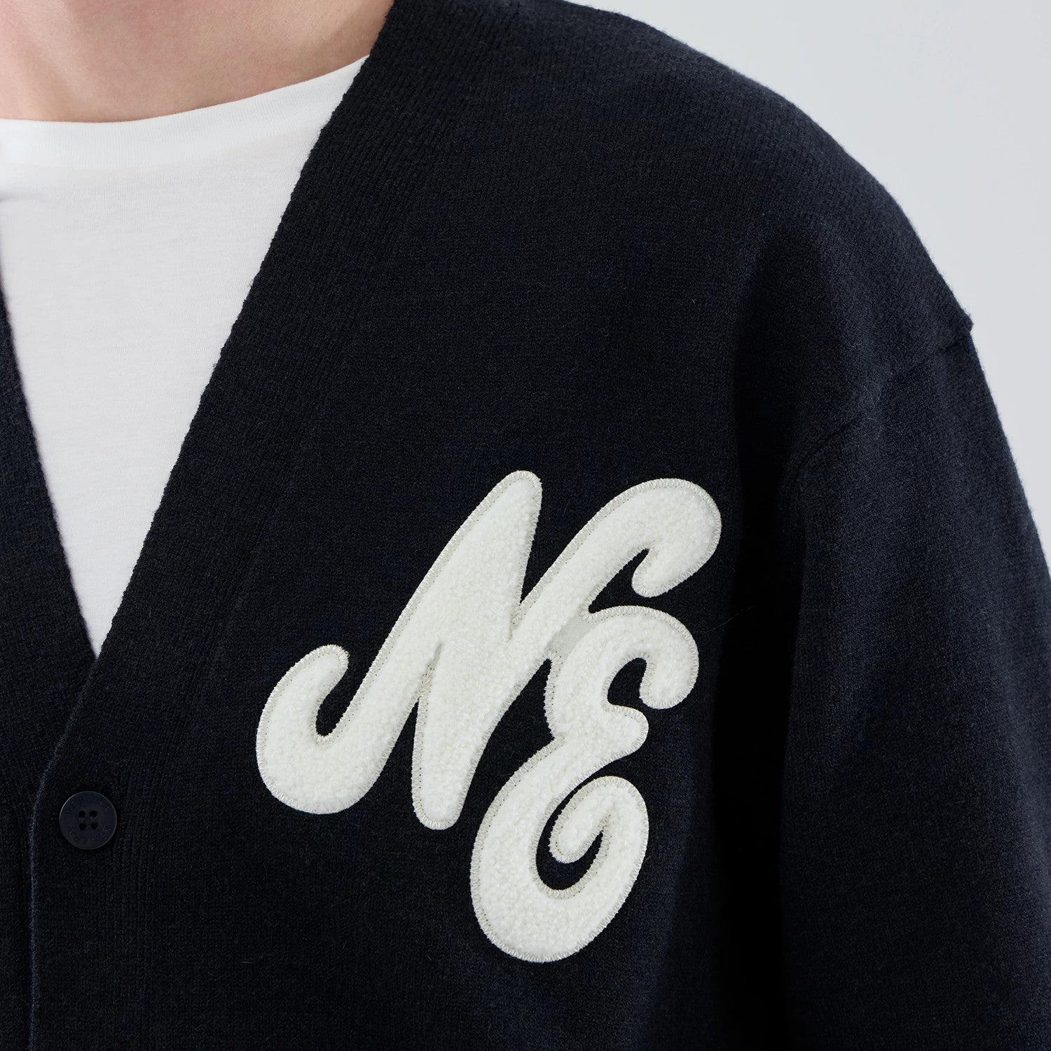 The model is wearing this New Era Heritage Cardigan in navy. 5