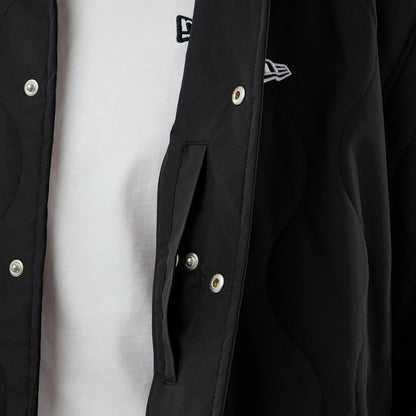 The model is wearing this New Era Quilted Coaches Jacket in black. 6