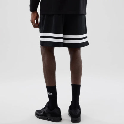 The model is wearing these MLB Mesh LA Dodgers Oversized Shorts in black. 2