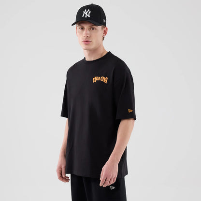 The model is wearing this New Era Food Graphic Oversized T-Shirt in black. 3