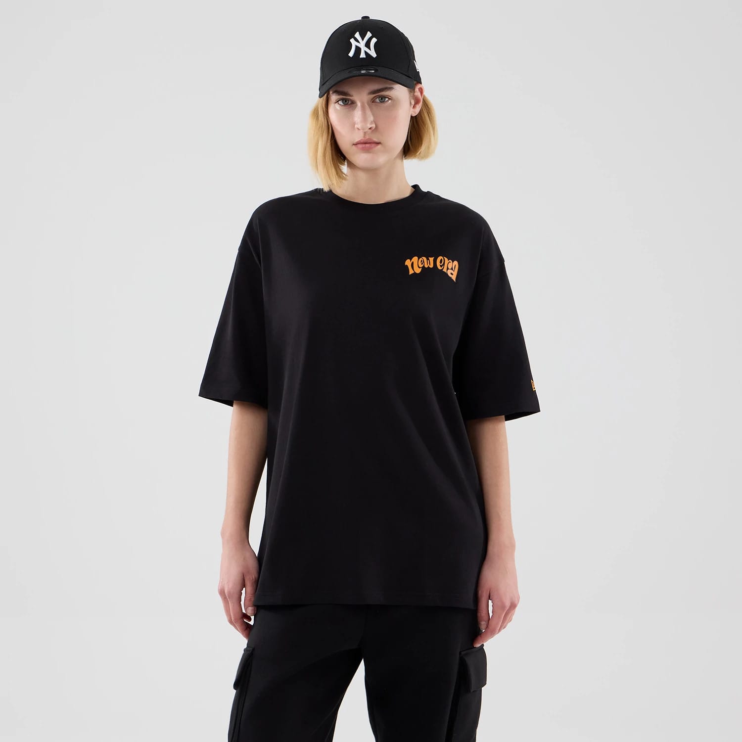 The model is wearing this New Era Food Graphic Oversized T-Shirt in black. 4