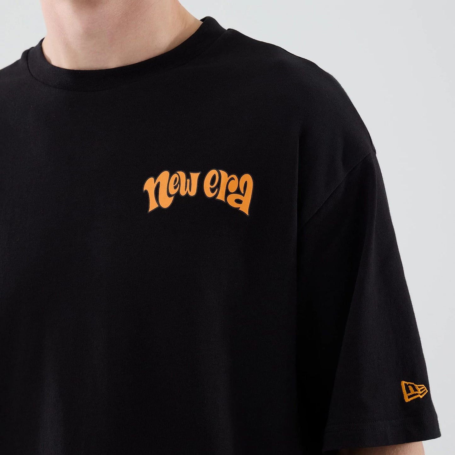 The model is wearing this New Era Food Graphic Oversized T-Shirt in black. 5