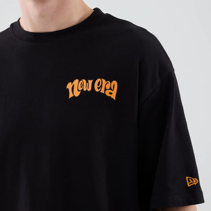 The model is wearing this New Era Food Graphic Oversized T-Shirt in black. 5