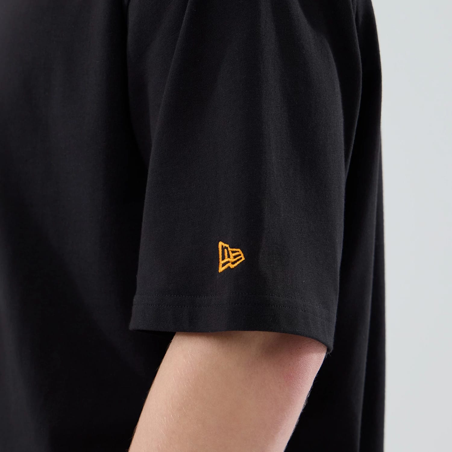 The model is wearing this New Era Food Graphic Oversized T-Shirt in black. 7