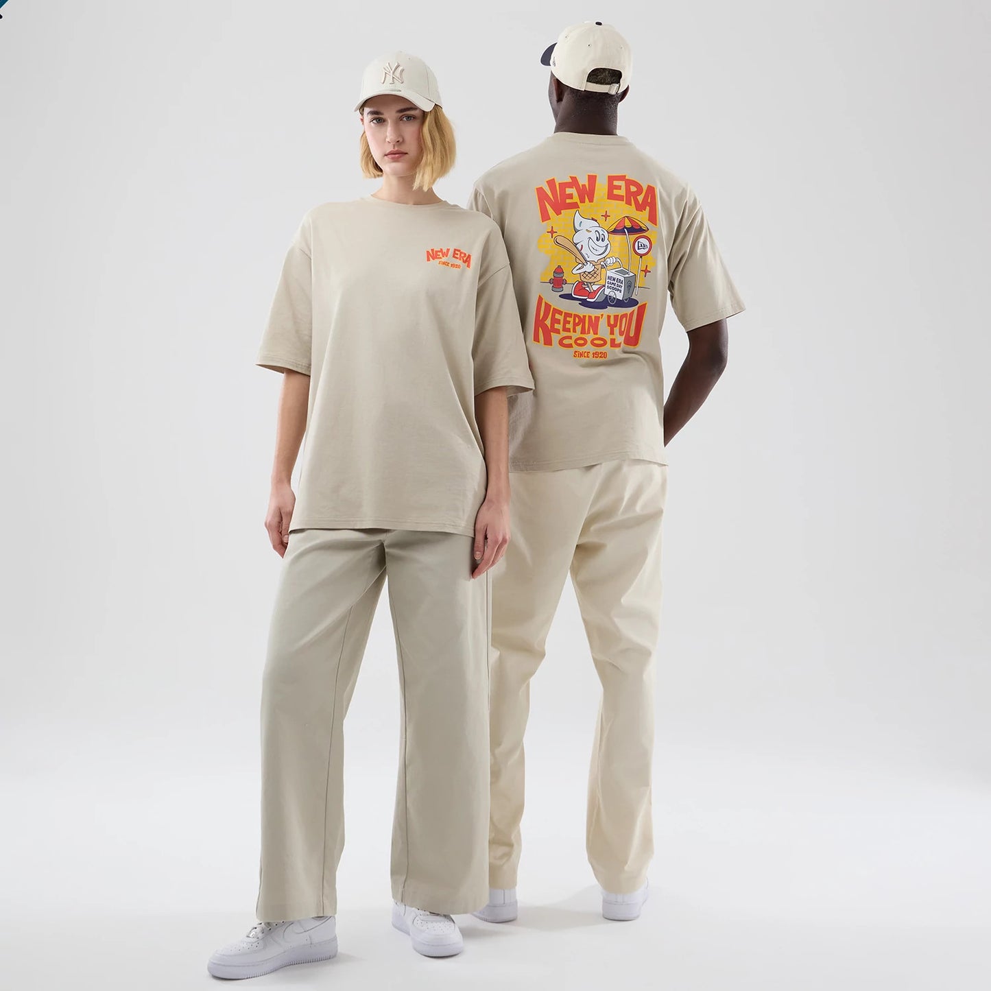 The model is wearing this New Era Food Graphic Oversized T-Shirt in light beige. 1