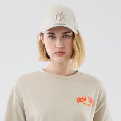 The model is wearing this New Era Food Graphic Oversized T-Shirt in light beige. 6