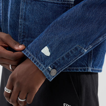 The model is wearing this New Era Denim Worker Jacket in dark blue. 5