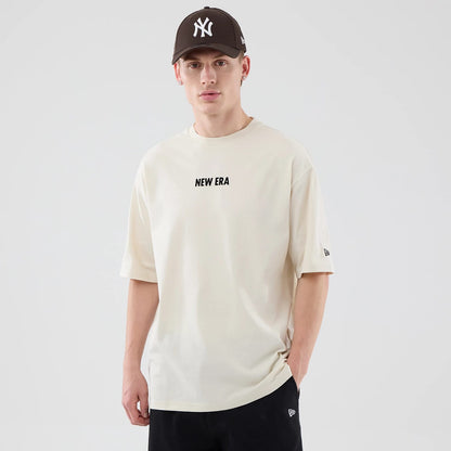 The model is wearing this New Era Cap Graphic Oversized T-Shirt in cream. 3